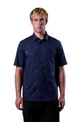 Man wearing a navy blue short-sleeve shirt against a black background